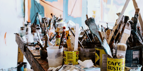 Cans of paint and paintbrushes